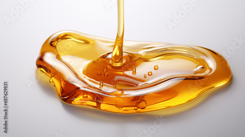 A single shot of honey, elixir, or oil on a plain white surface.