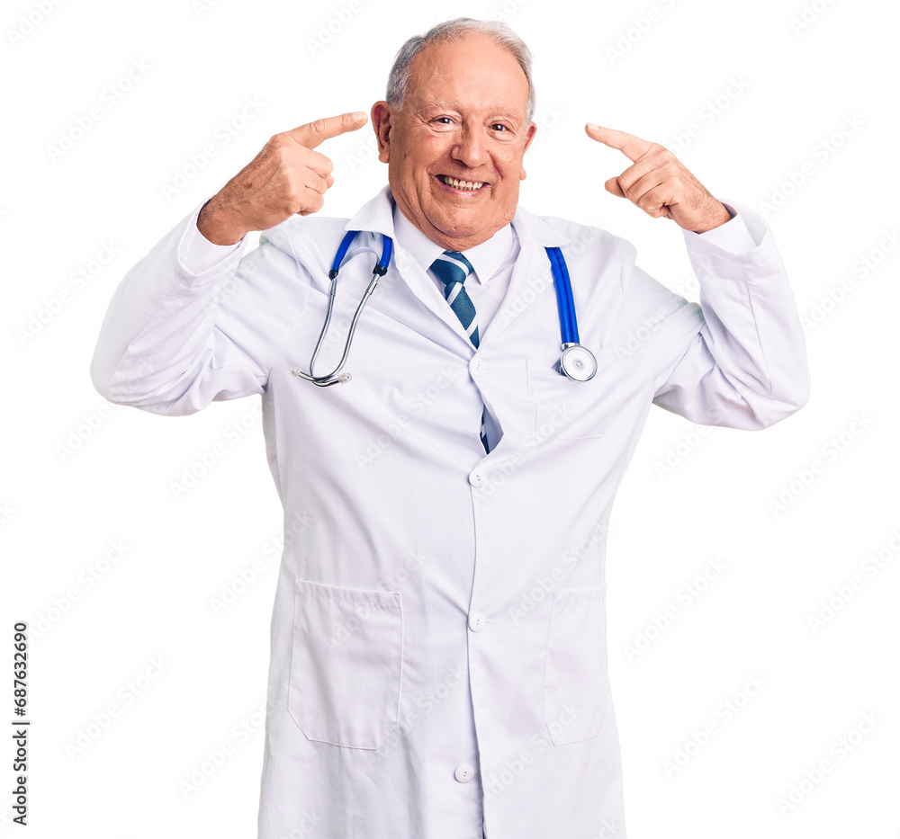 Senior handsome grey-haired man wearing doctor coat and stethoscope smiling pointing to head with both hands finger, great idea or thought, good memory Senior handsome grey-haired man wearing doctor coat and stethoscope smiling pointing to head with both hands finger, great idea or thought, good memory