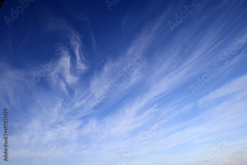 Beautiful blue sky with white wispy clouds, a perfect replacement background for photos. photo