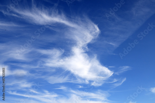 Beautiful blue sky with white wispy clouds, a perfect replacement background for photos. photo
