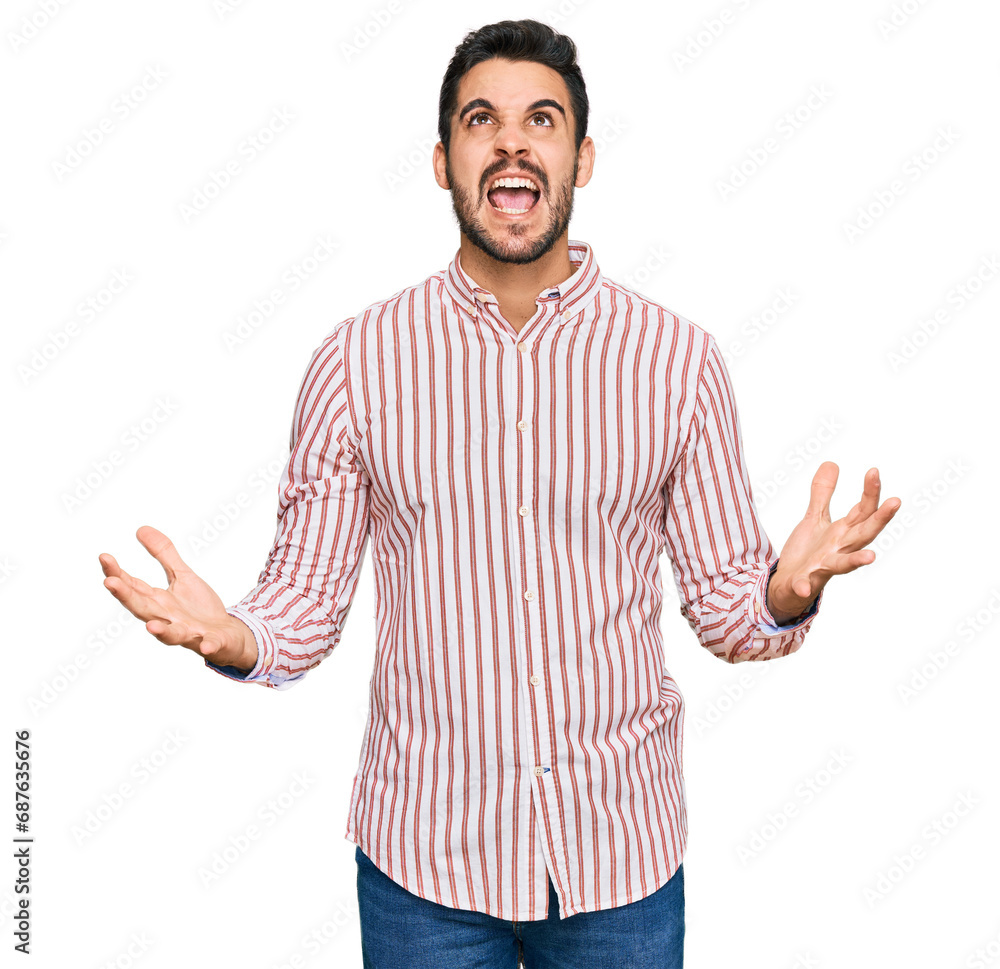 Young hispanic man wearing business shirt crazy and mad shouting and yelling with aggressive expression and arms raised. frustration concept. Young hispanic man wearing business shirt crazy and mad shouting and yelling with aggressive expression and arms raised. frustration concept.