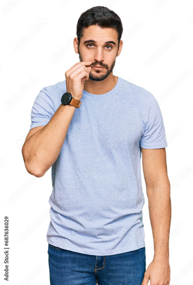 Young hispanic man wearing casual clothes mouth and lips shut as zip with fingers. secret and silent, taboo talking Young hispanic man wearing casual clothes mouth and lips shut as zip with fingers. secret and silent, taboo talking