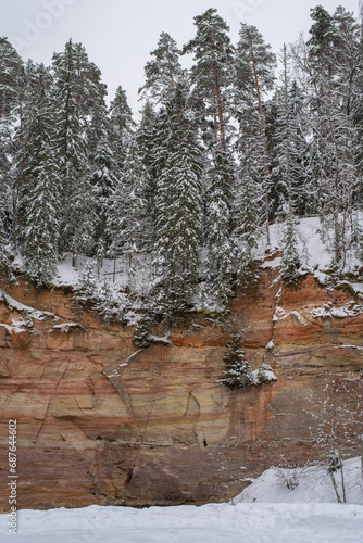 Beautiful sandstone cliffs in South Estonia, Taevaskoja (Taevaskoda) nature trail on a cloudy winter day, engraved writings and names on the cliff by tourists. photo