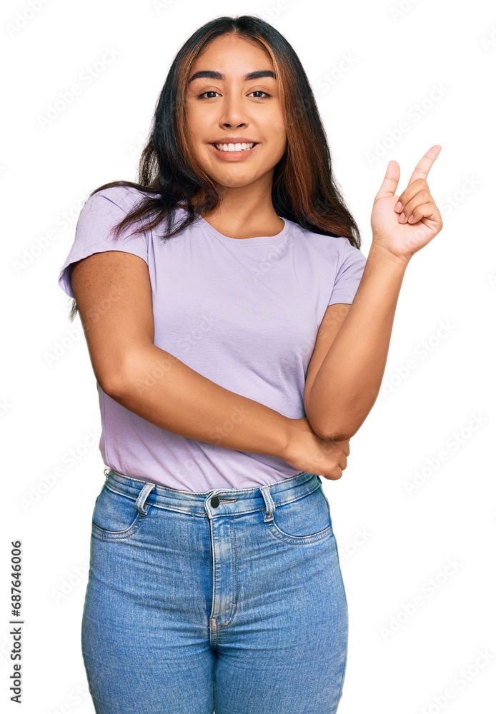 Young latin woman wearing casual clothes with a big smile on face, pointing with hand and finger to the side looking at the camera. Young latin woman wearing casual clothes with a big smile on face, pointing with hand and finger to the side looking at the camera.