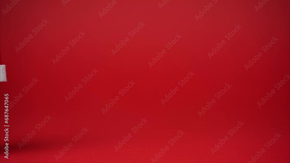 The US dollar notes different denomination with santa claus hat. Stop motion animation presidents portraits on money moving on red festive background The US dollar notes different denomination with santa claus hat. Stop motion animation presidents portraits on money moving on red festive background