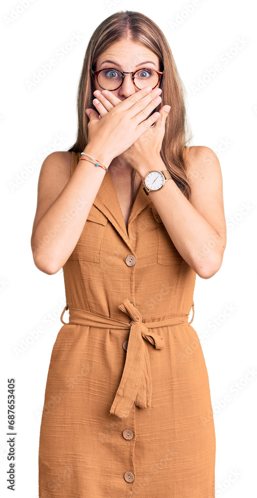 Young beautiful blonde woman wearing casual clothes and glasses shocked covering mouth with hands for mistake. secret concept. Young beautiful blonde woman wearing casual clothes and glasses shocked covering mouth with hands for mistake. secret concept.