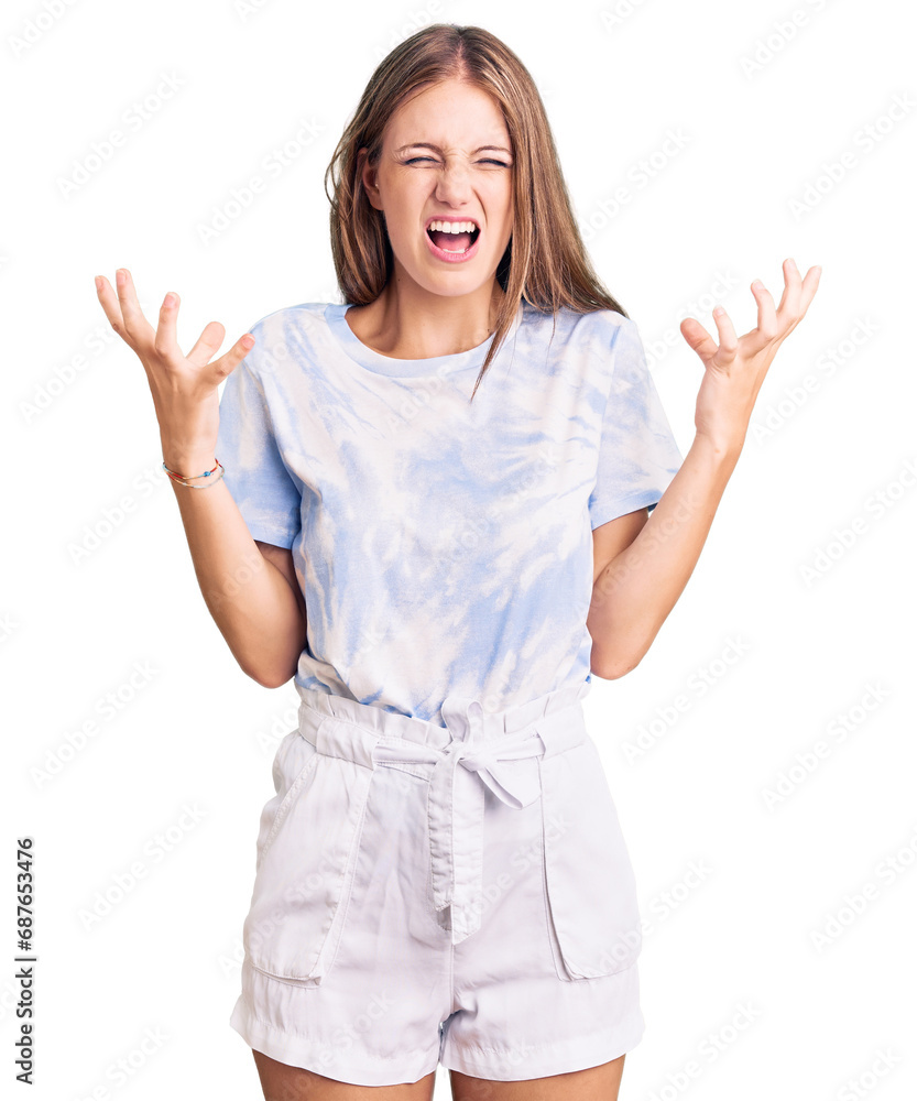 Young beautiful blonde woman wearing tye die tshirt crazy and mad shouting and yelling with aggressive expression and arms raised. frustration concept. Young beautiful blonde woman wearing tye die tshirt crazy and mad shouting and yelling with aggressive expression and arms raised. frustration concept.