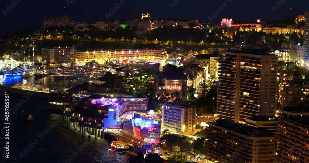 Aerial Shot Of Illuminated Buildings In Residential City, Drone Flying Forward Over Sea At Night - Monte Carlo, Monaco Aerial Shot Of Illuminated Buildings In Residential City, Drone Flying Forward Over Sea At Night - Monte Carlo, Monaco