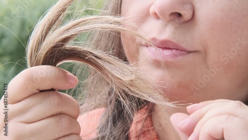 Examining role of hair inspection self-care routine and impact on self-image, mature woman examines Dry hair, brittle, split ends, Hair Health and Maintenance photo