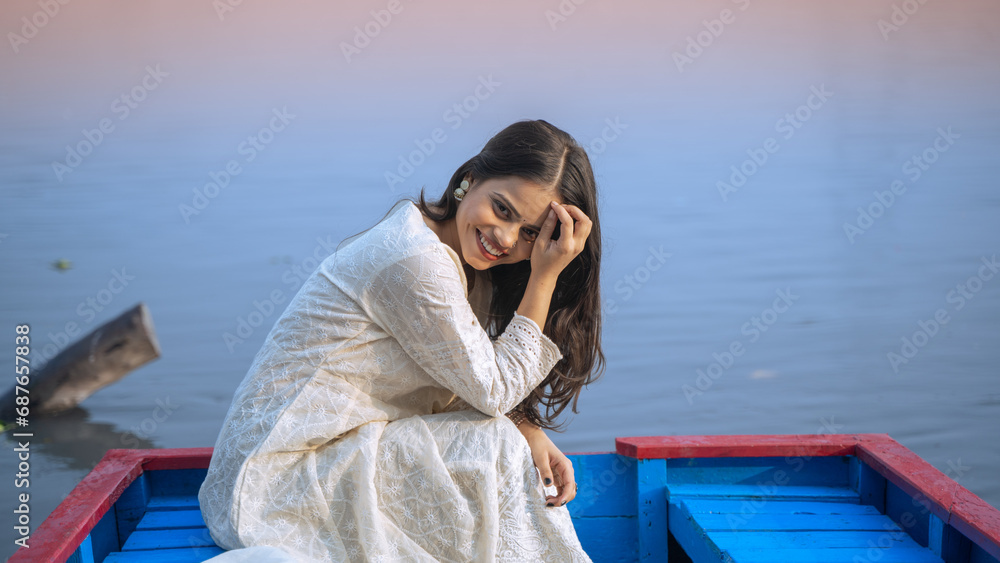Portrait of a beautiful Indian girl, wearing traditional dress, outdoor nature background