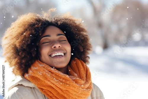 happy smiling african woman closed eyes in snow enjoing moments photo