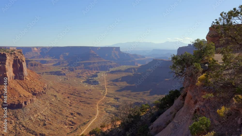 Establishing shot of mountains with red rocks in Shafer Canyon Overlook, Canyonlands National Park, Utah, North America. Day time on October 2023. Still camera view. ProRes 422 HQ.
