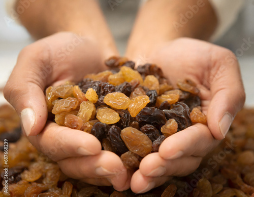 Cupped hands holding raisins