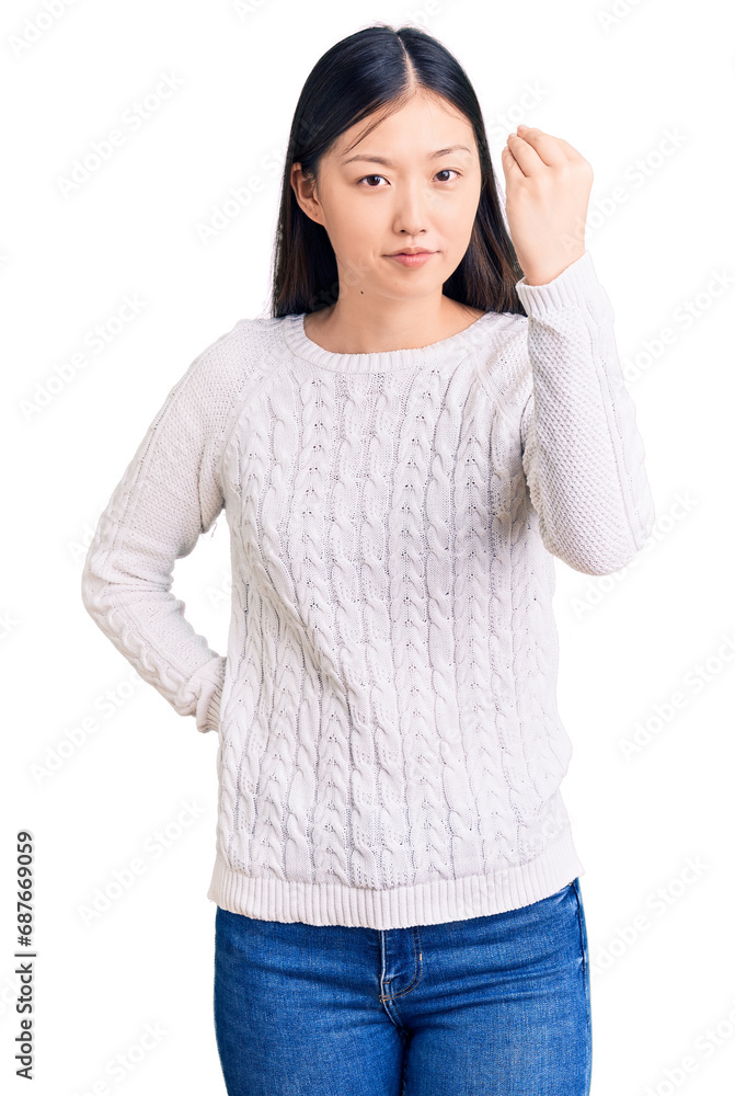 Young beautiful chinese woman wearing casual sweater doing italian gesture with hand and fingers confident expression Young beautiful chinese woman wearing casual sweater doing italian gesture with hand and fingers confident expression