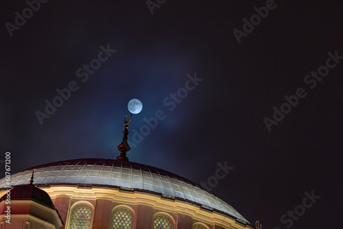 Islamic background photo. Full moon and a dome of a mosque photo