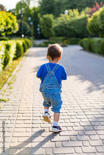 A Curious Little Boy Exploring the World Around Him. A little boy that is walking down a sidewalk