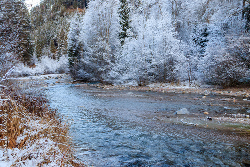 View of winter river in the Swiss Alps, Switzerland. Snowy mountain river landscape