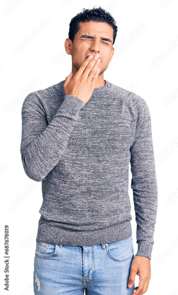 Hispanic handsome young man wearing casual sweater bored yawning tired covering mouth with hand. restless and sleepiness. Hispanic handsome young man wearing casual sweater bored yawning tired covering mouth with hand. restless and sleepiness.
