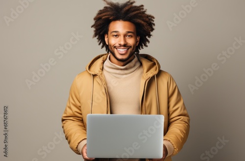 a black man is holding a laptop laptop,