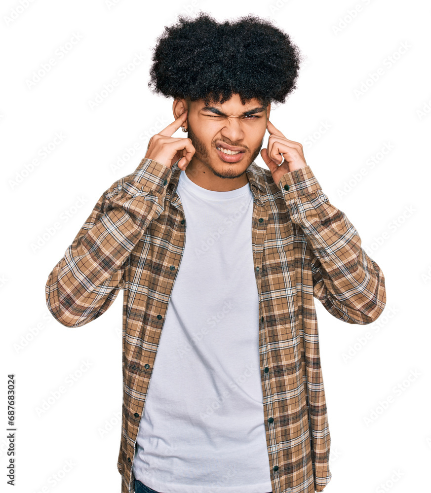 Young african american man with afro hair wearing casual clothes covering ears with fingers with annoyed expression for the noise of loud music. deaf concept. Young african american man with afro hair wearing casual clothes covering ears with fingers with annoyed expression for the noise of loud music. deaf concept.