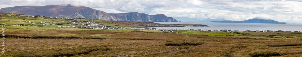 Panorama of bog with village and mountains in background