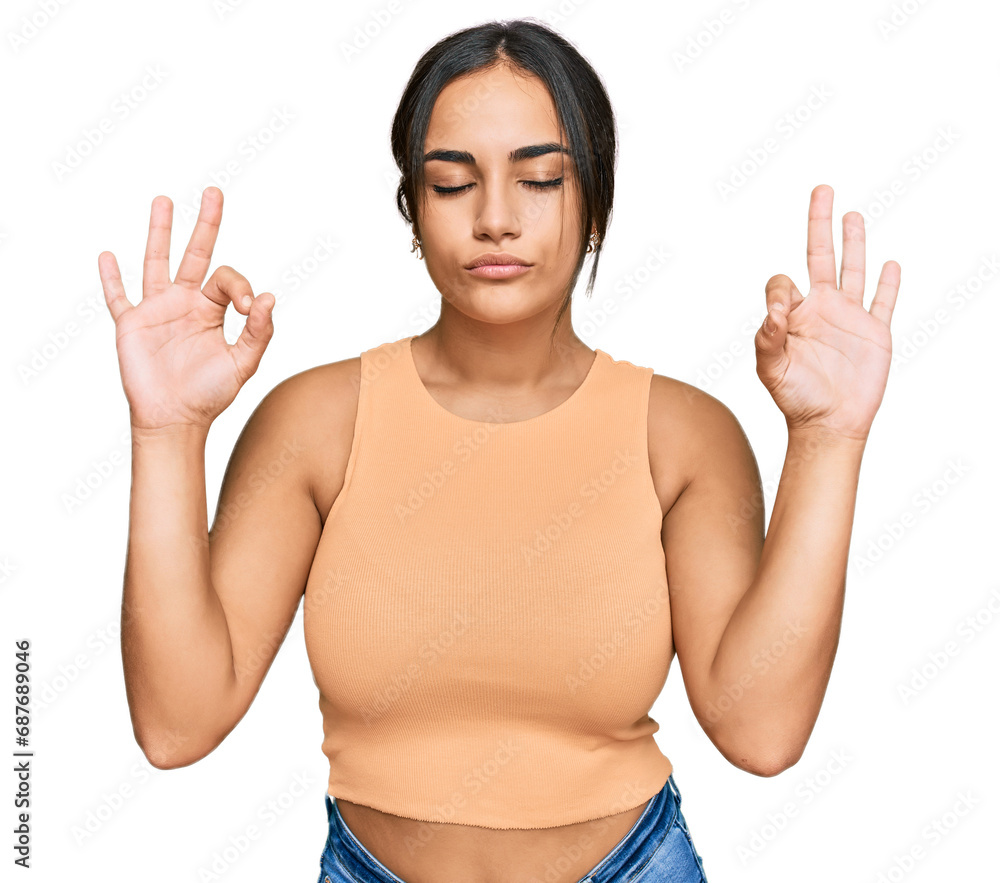 Young brunette woman wearing casual clothes relax and smiling with eyes closed doing meditation gesture with fingers. yoga concept.