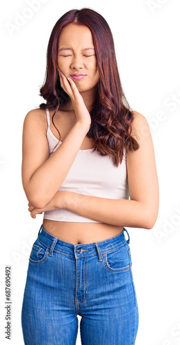 Young beautiful chinese girl wearing casual clothes touching mouth with hand with painful expression because of toothache or dental illness on teeth. dentist