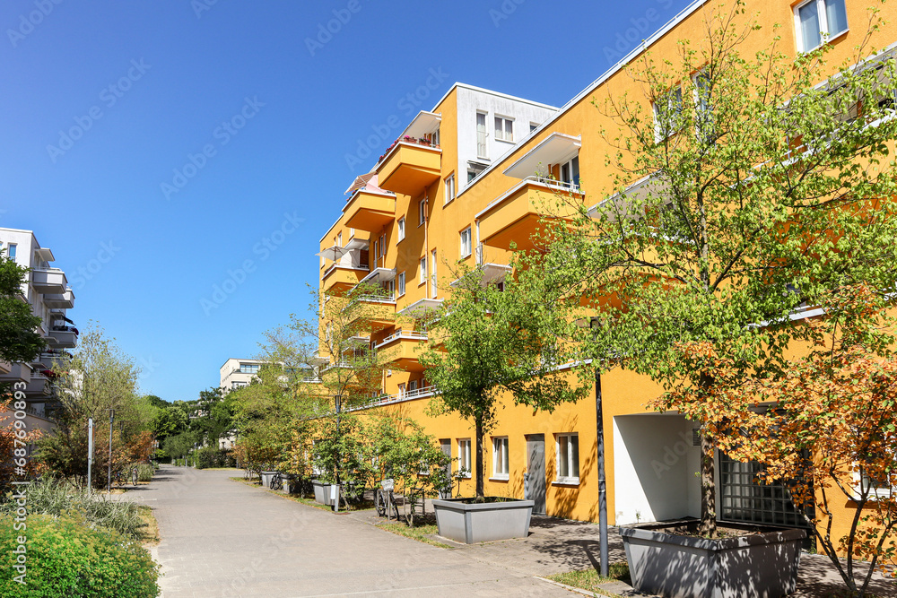 Residential area with ecological and sustainable green residential buildings, low-energy houses with apartments and green courtyard - obrazy, fototapety, plakaty 