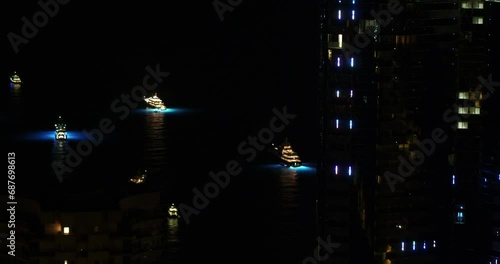 Wallpaper Mural Aerial Shot Of Illuminated Passenger Crafts Moving In Sea, Drone Flying Backwards By Buildings At Night - Monte Carlo, Monaco Torontodigital.ca