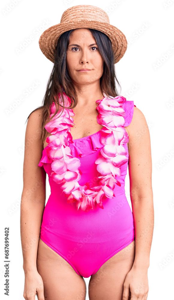 Young beautiful brunette woman wearing swimwear and hawaiian lei depressed and worry for distress, crying angry and afraid. sad expression.