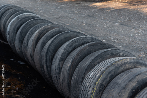 Used tire dump,  rubber waste and recycling challenges. Tires of various sizes and brands are piled up in irregular stacks, disturbing landscape of industrial waste