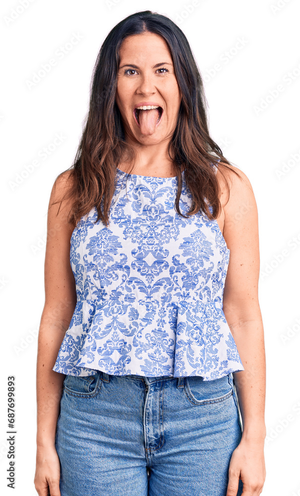 Young beautiful brunette woman wearing casual t-shirt sticking tongue out happy with funny expression. emotion concept. Young beautiful brunette woman wearing casual t-shirt sticking tongue out happy with funny expression. emotion concept.