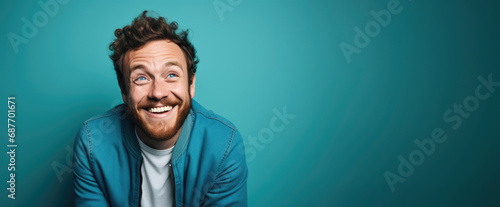 A portrait capturing a man's delighted expression, radiating joy against a lively turquoise canvas