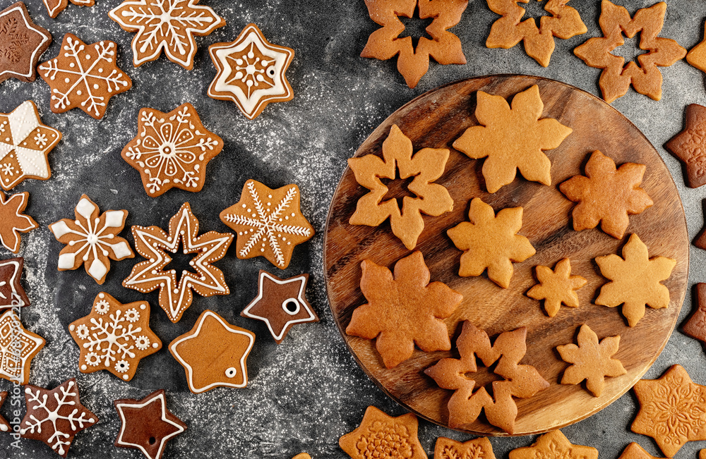 Various christmas gingerbread cookies on dark table with flour Various christmas gingerbread cookies on dark table with flour