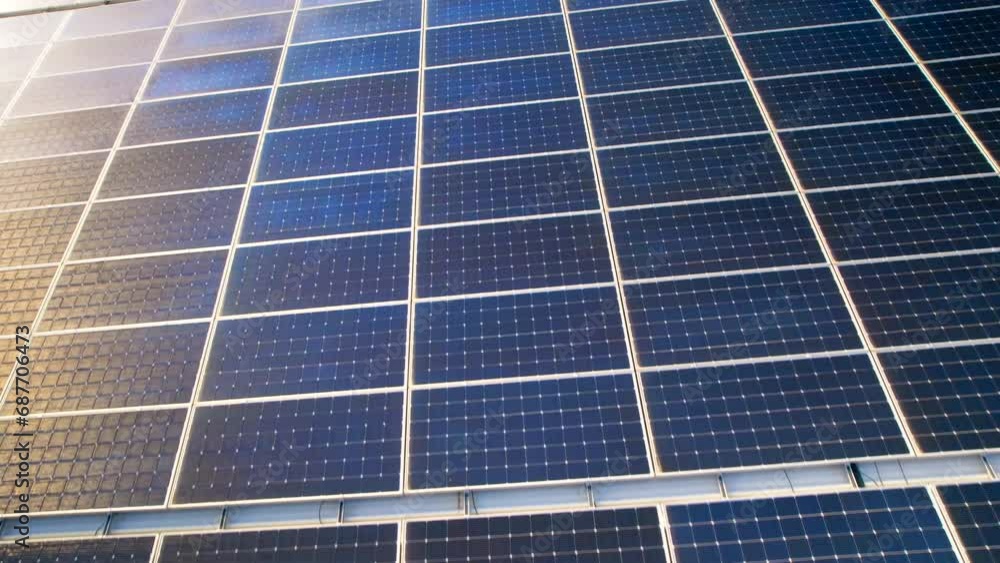 Aerial drone view of blue solar panels installed on a high efficient energy factory roof Aerial drone view of blue solar panels installed on a high efficient energy factory roof