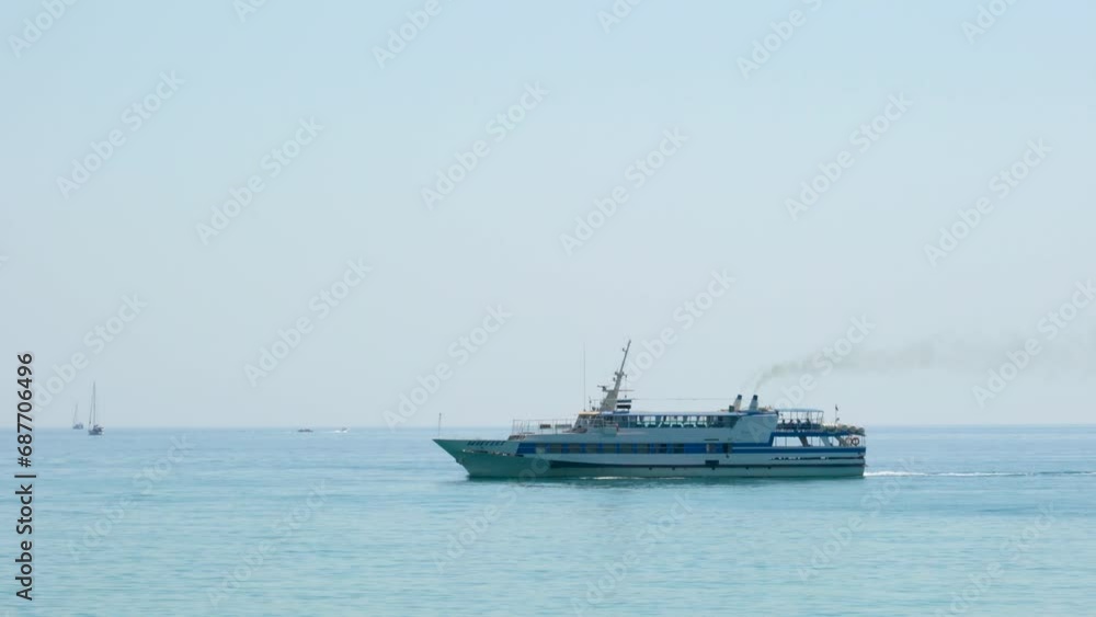 A pleasure boat sails against the sky A pleasure boat sails against the sky