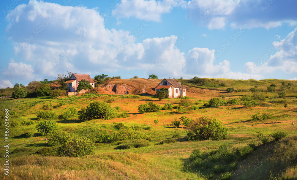 Pastoral landscape with old houses in a field Pastoral landscape with old houses in a field