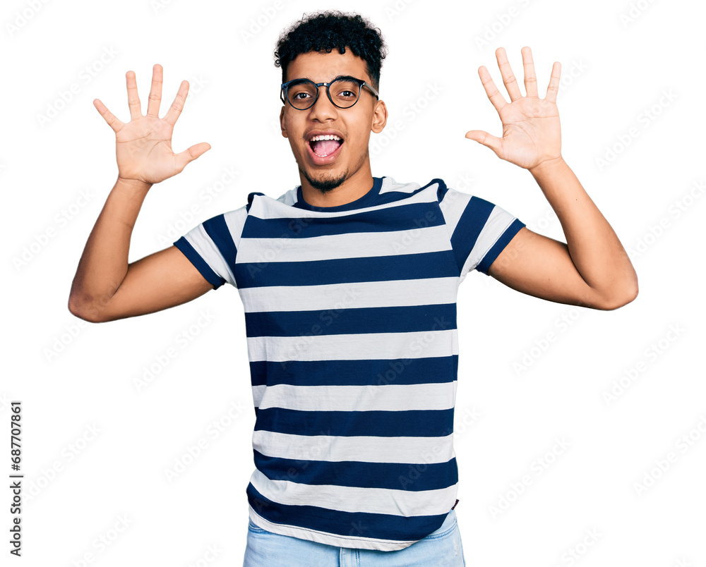 Young african american man wearing casual clothes and glasses showing and pointing up with fingers number ten while smiling confident and happy. Young african american man wearing casual clothes and glasses showing and pointing up with fingers number ten while smiling confident and happy.