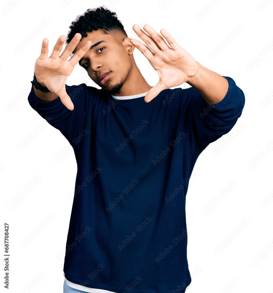 Young african american man wearing casual clothes doing frame using hands palms and fingers, camera perspective Young african american man wearing casual clothes doing frame using hands palms and fingers, camera perspective
