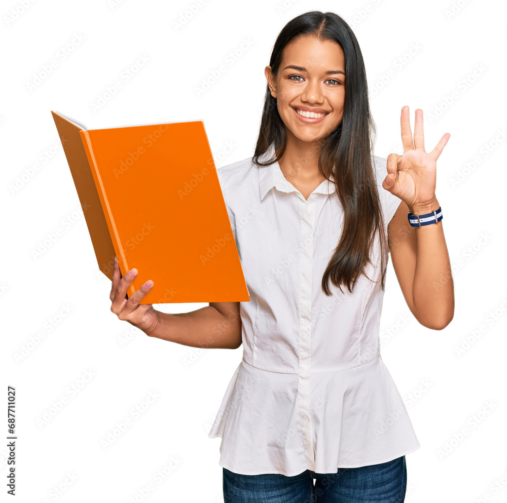 Beautiful hispanic woman reading book doing ok sign with fingers, smiling friendly gesturing excellent symbol Beautiful hispanic woman reading book doing ok sign with fingers, smiling friendly gesturing excellent symbol