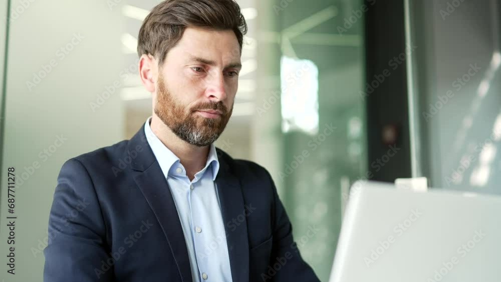 Busy businessman works on a laptop while sitting at workplace in business office. Entrepreneur in a formal suit typing massage chatting banking in computer app, using software application. Close up Busy businessman works on a laptop while sitting at workplace in business office. Entrepreneur in a formal suit typing massage chatting banking in computer app, using software application. Close up
