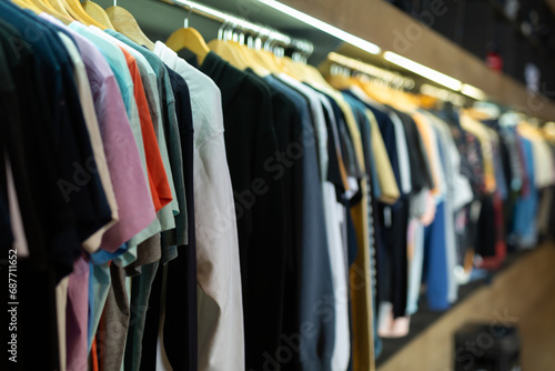 Assorted casual clothes on shelves and hangers at shopping mall