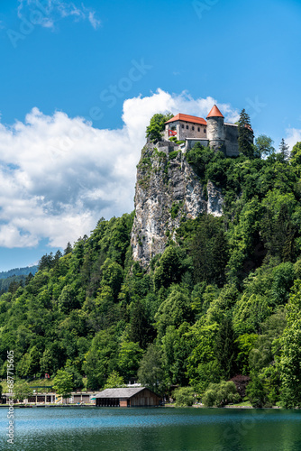 Beautiful view of Lake Bled and Bled Castle above the cliff on a sunny summer day with blue sky cloud, Bled, Slovenia