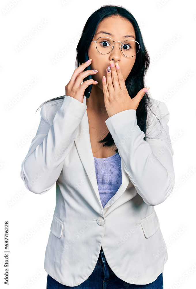 Beautiful hispanic woman with nose piercing having conversation talking on the smartphone covering mouth with hand, shocked and afraid for mistake. surprised expression Beautiful hispanic woman with nose piercing having conversation talking on the smartphone covering mouth with hand, shocked and afraid for mistake. surprised expression