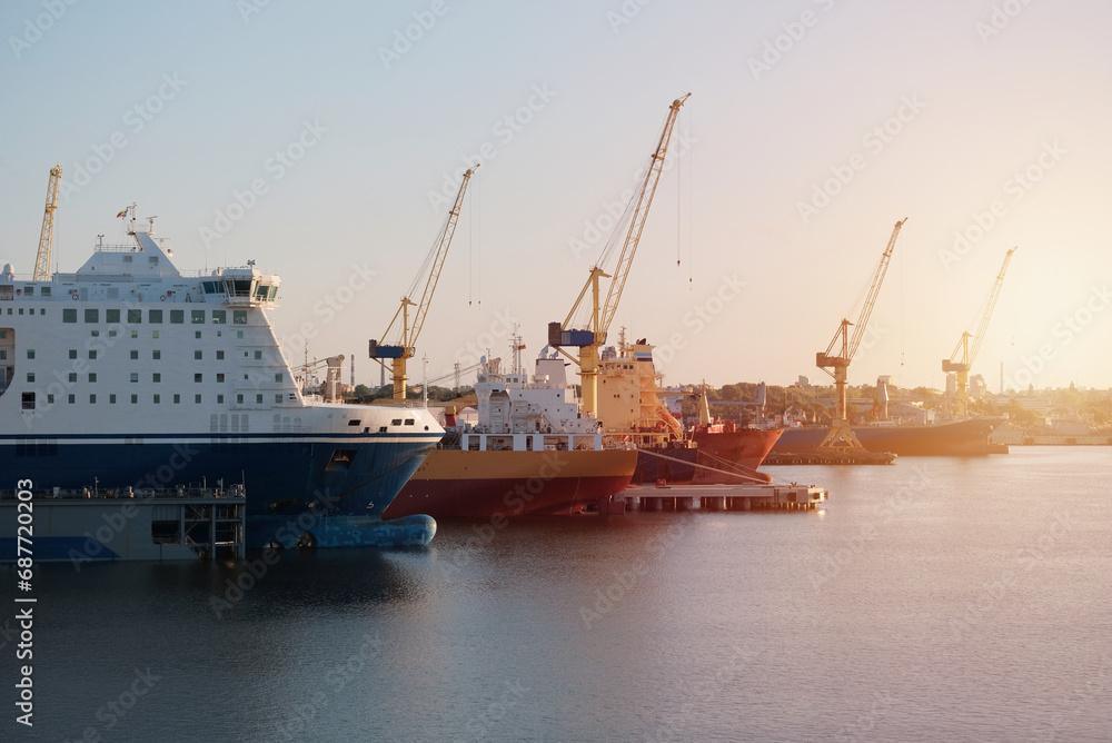 Fototapeta premium Different Type Vessels During The Dry-Docking Period and Essential Engine Repairs. Hull Survey Of The Ships. Ships In The Shipyard. Shipbuilding.