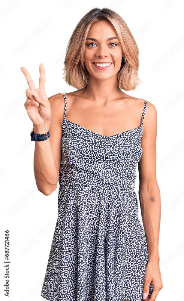 Beautiful caucasian woman wearing summer dress showing and pointing up with fingers number two while smiling confident and happy. Beautiful caucasian woman wearing summer dress showing and pointing up with fingers number two while smiling confident and happy.