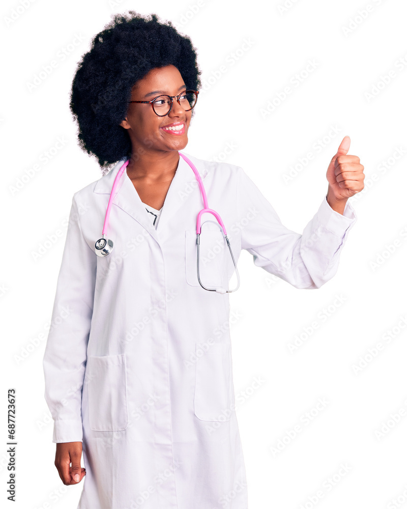 Young african american woman wearing doctor coat and stethoscope looking proud, smiling doing thumbs up gesture to the side Young african american woman wearing doctor coat and stethoscope looking proud, smiling doing thumbs up gesture to the side