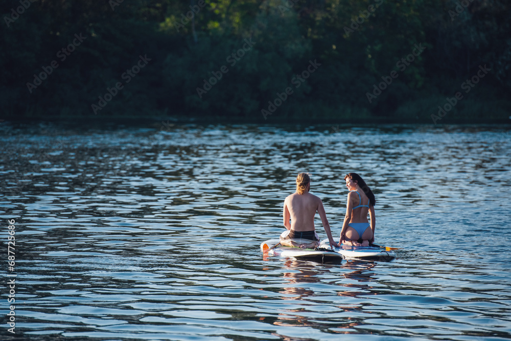 Fototapeta premium Couple standup paddleboarding