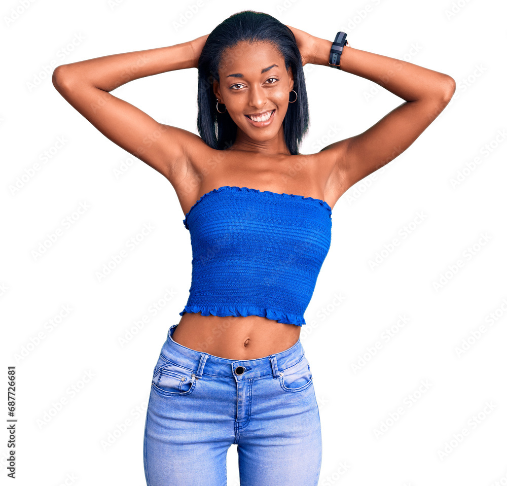 Young african american woman wearing casual summer clothes relaxing and stretching, arms and hands behind head and neck smiling happy Young african american woman wearing casual summer clothes relaxing and stretching, arms and hands behind head and neck smiling happy