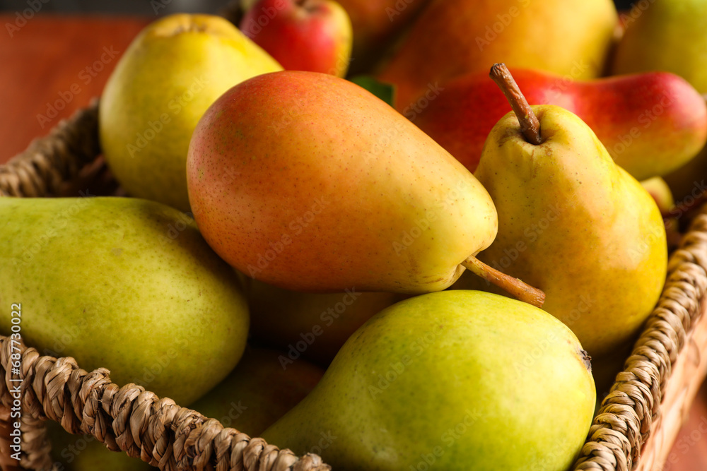 Fresh ripe pears in wicker box, closeup